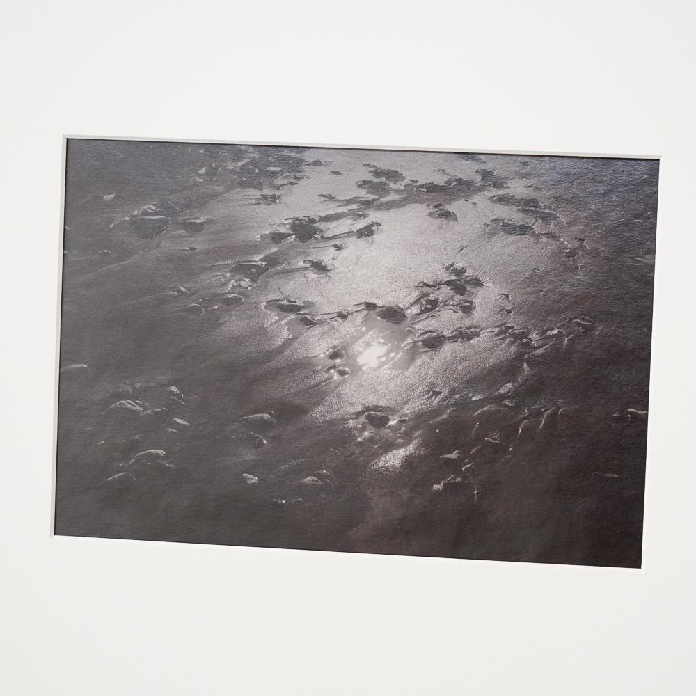 Sand and Sun #6 by Kino Koike, a vertical limited-edition artwork featuring natural landscapes and photographic and realistic imagery, in black and white and grey tones.