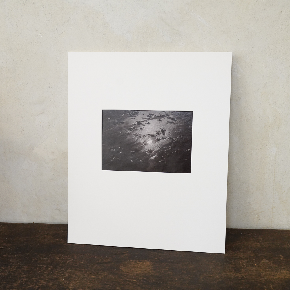 Sand and Sun #6 by Kino Koike, a vertical limited-edition artwork featuring natural landscapes and photographic and realistic imagery, in black and white and grey tones.