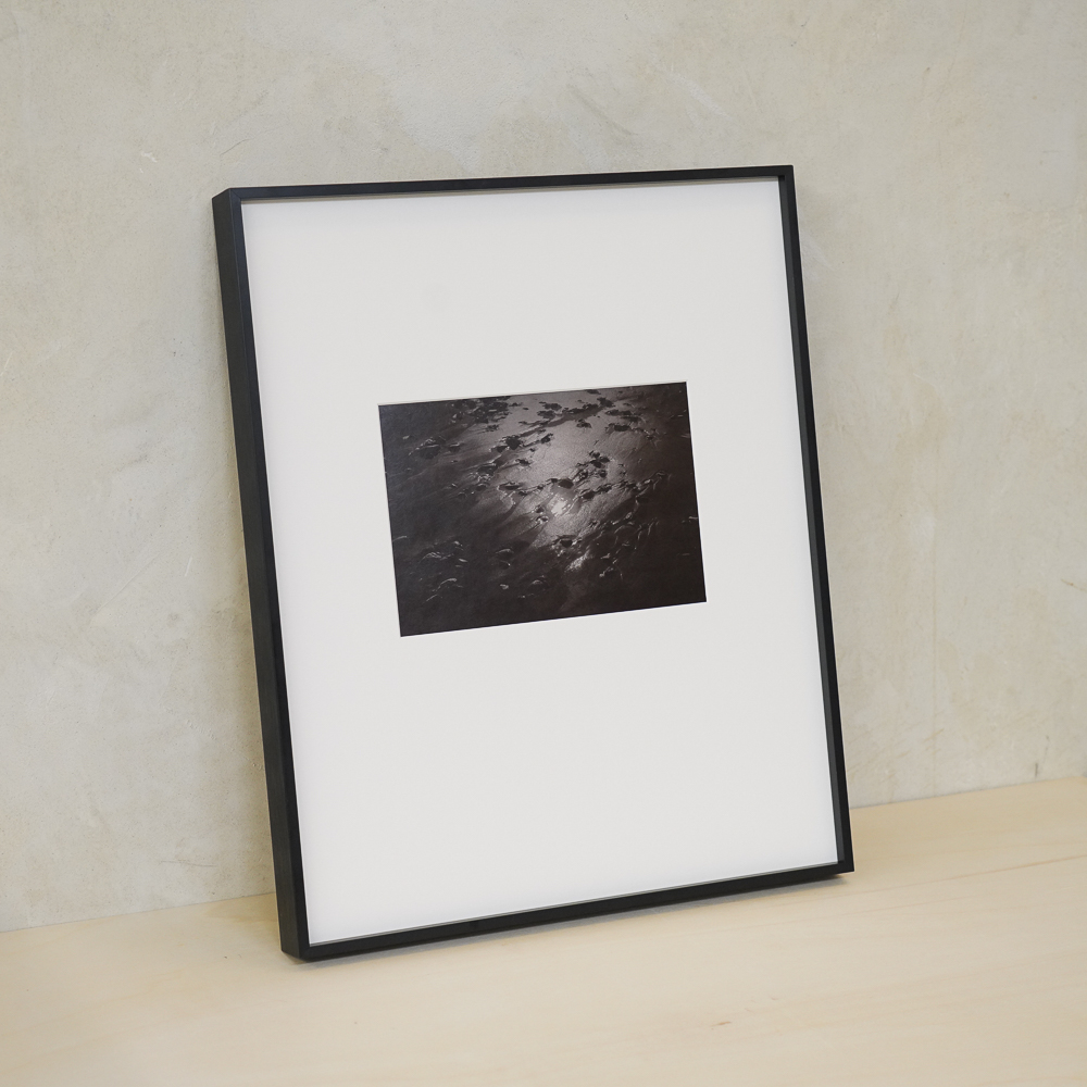 Sand and Sun #6 by Kino Koike, a vertical limited-edition artwork featuring natural landscapes and photographic and realistic imagery, in black and white and grey tones.
