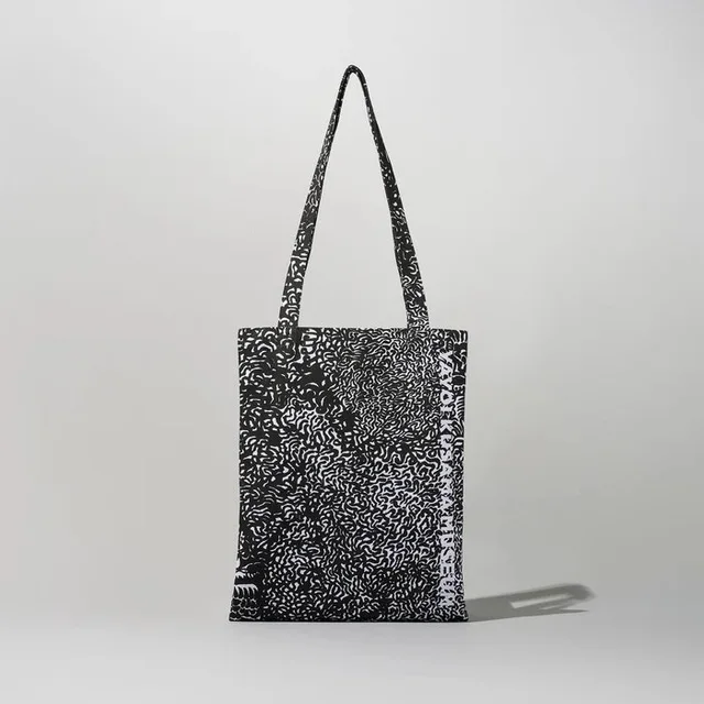 Tote Bag (Black) by Yayoi Kusama, an artist-designed object featuring abstract lines and Japanese print imagery, in black and white tones. Cover image.